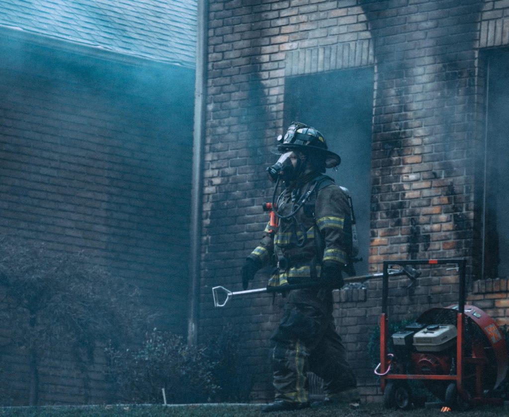 Firefighter exiting a burned building