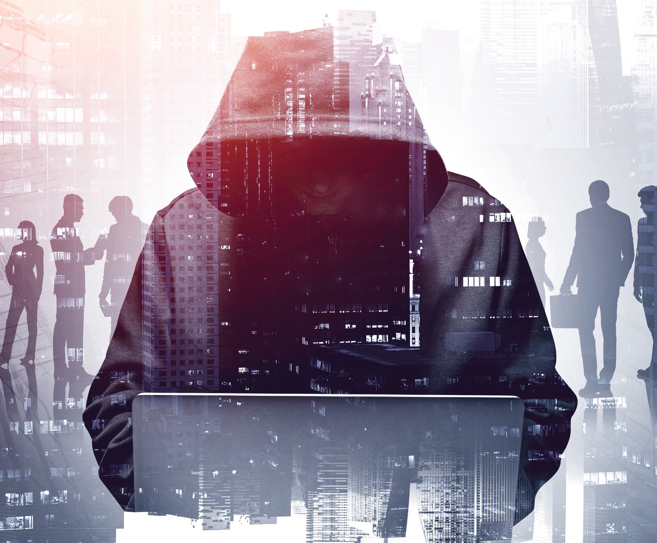 man with a hoodie over his head on a computer