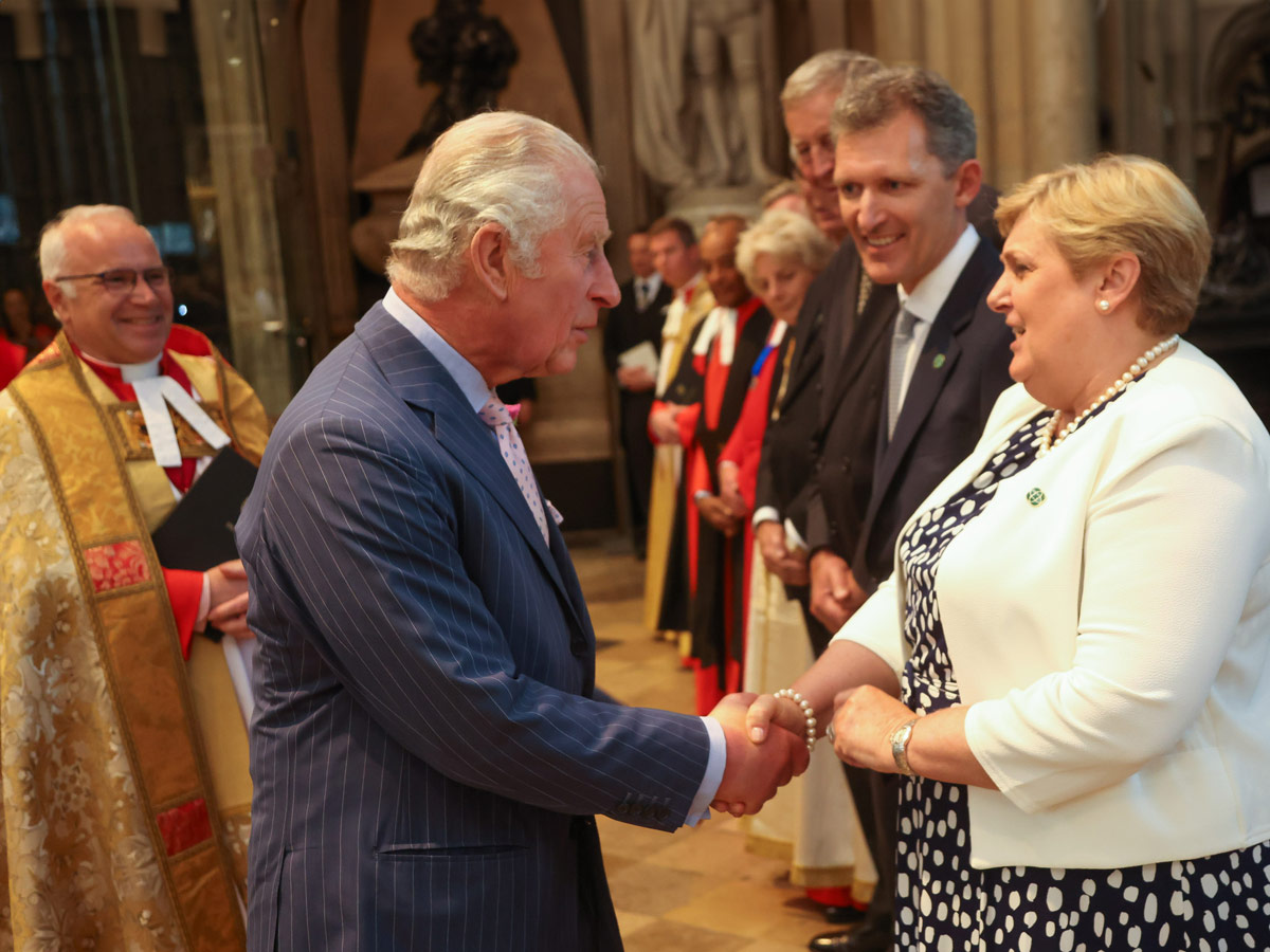 Jacinta Whyte shakes hands with King Charles in a church setting