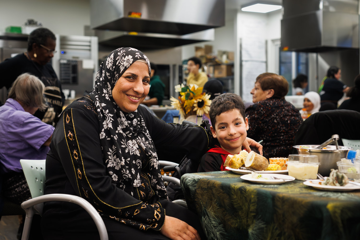 HopeBlooms-42-sm Woman and her son eating a meal at a soup kitchen