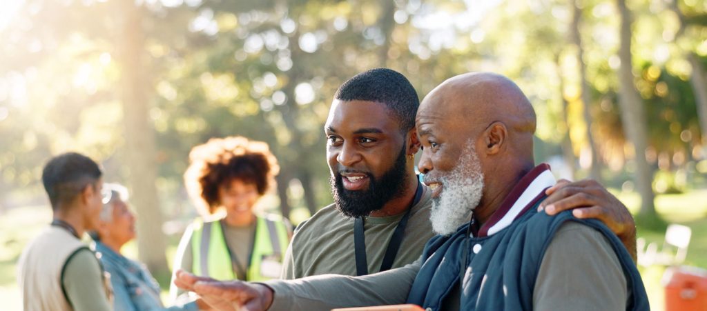 Two volunteers outdoors looking over a clipboard
