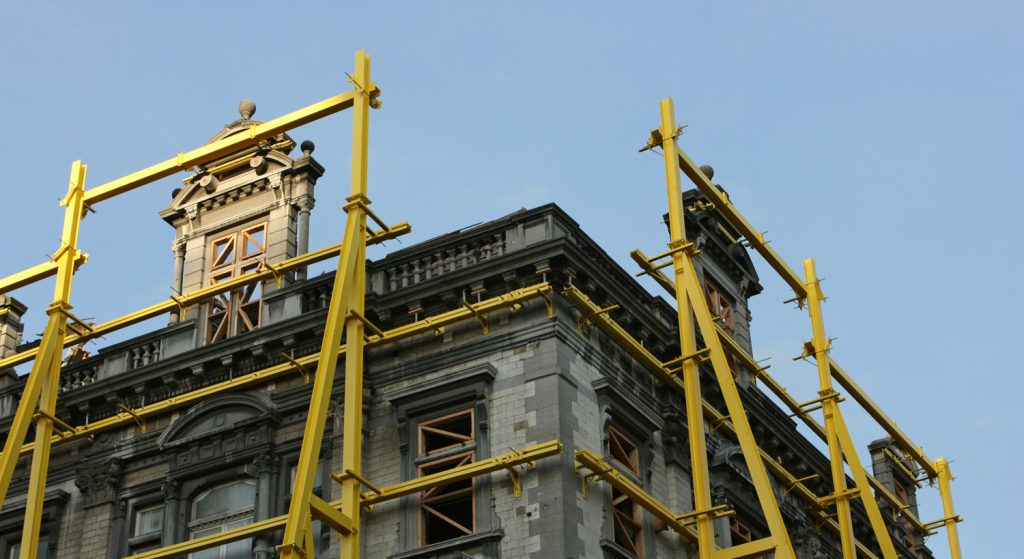 The roof of a heritage building with scaffolding, under renovation