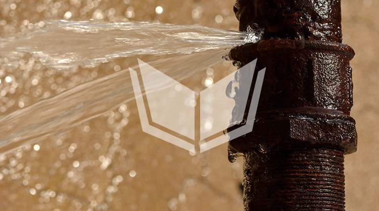 A close up of a bursting pipe