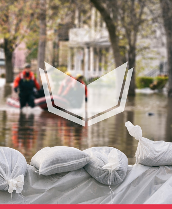 Flooded city street with sand bags in the foreground