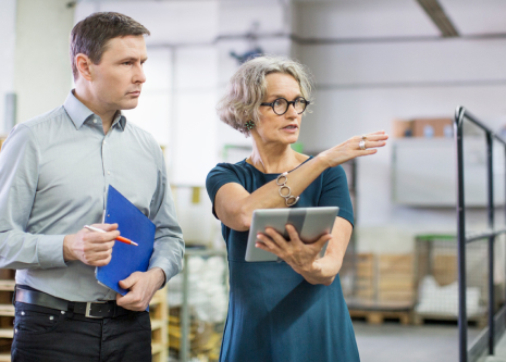 Two people inspecting something