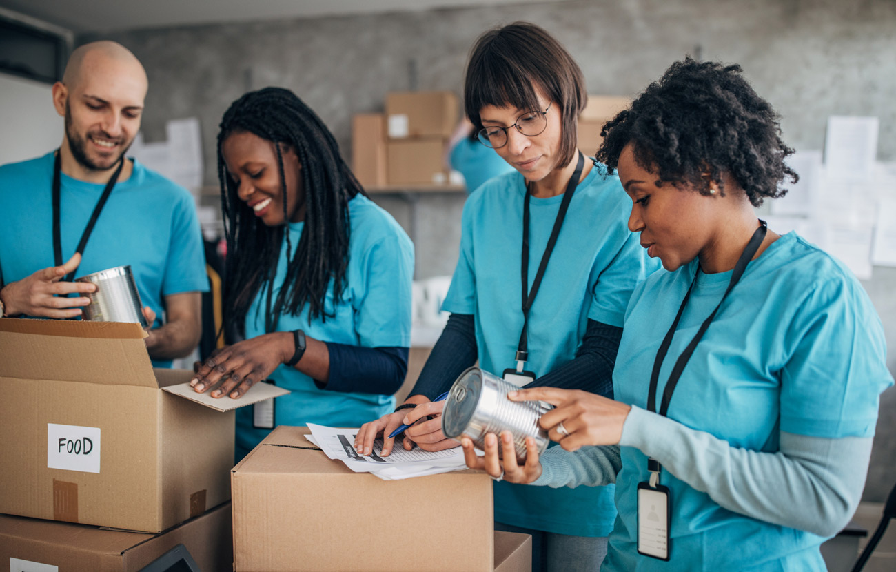 Group of volunteers packs boxes for charity