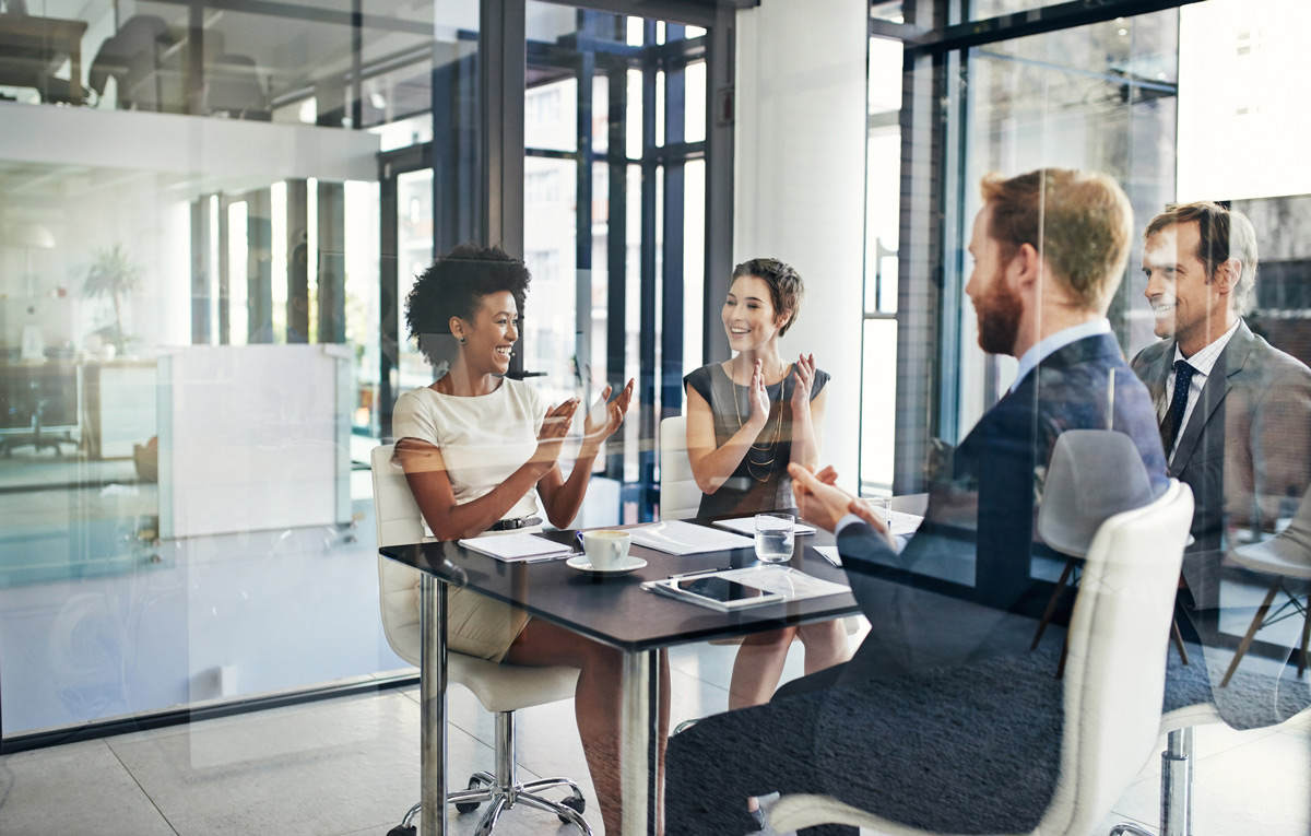 Group of co-workers sitting at a table and having a meeting