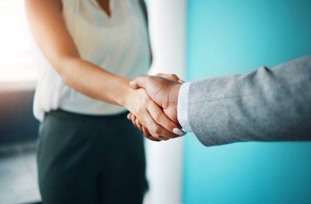 Close up of two business people shaking hands