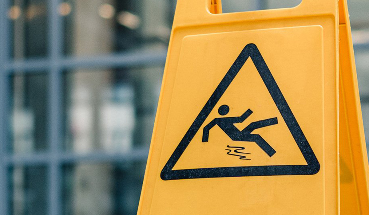 Close up of an A sign with slippery floor alert